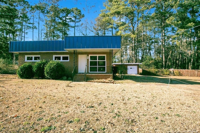 1453 Pamalee Dr, Fayetteville, NC 28303 - view of front of home featuring brick siding and a garage