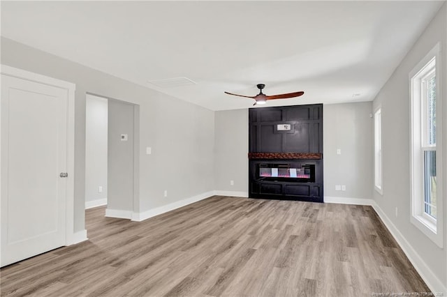 4037 Fulford Mcmillan Rd, Raeford, NC 28376 - unfurnished living room with light wood-style flooring, a ceiling fan, and baseboards