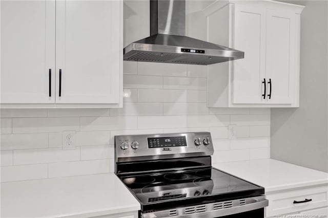 4037 Fulford Mcmillan Rd, Raeford, NC 28376 - kitchen with wall chimney exhaust hood, electric range, light countertops, and white cabinetry