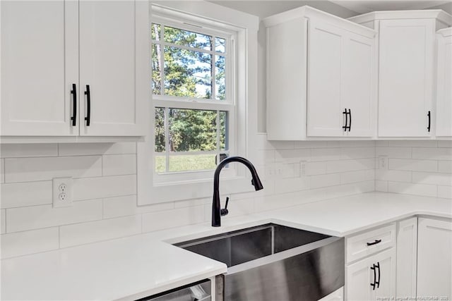 4037 Fulford Mcmillan Rd, Raeford, NC 28376 - kitchen featuring a sink, decorative backsplash, light countertops, and white cabinetry