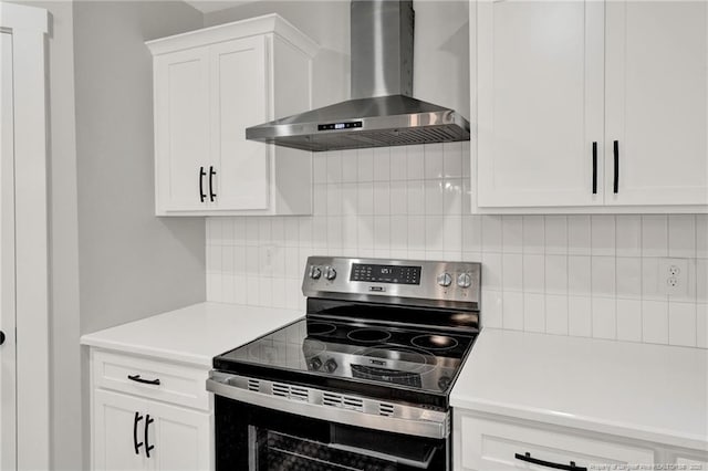4037 Fulford Mcmillan Rd, Raeford, NC 28376 - kitchen featuring electric range, wall chimney range hood, light countertops, white cabinets, and backsplash