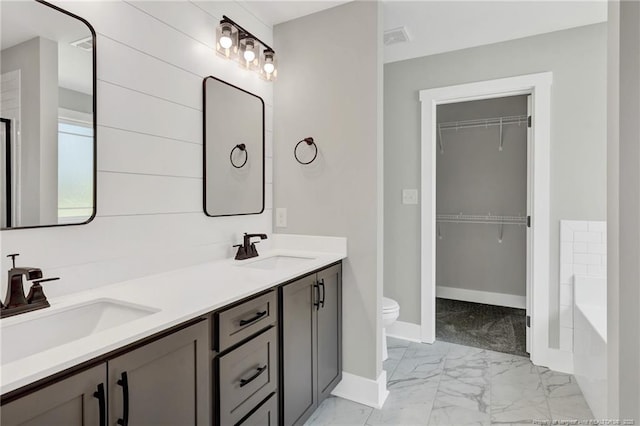 4037 Fulford Mcmillan Rd, Raeford, NC 28376 - bathroom with marble finish flooring, baseboards, toilet, double vanity, and a tub to relax in