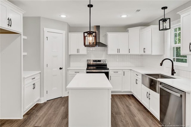 4037 Fulford Mcmillan Rd, Raeford, NC 28376 - kitchen featuring stainless steel appliances, wall chimney exhaust hood, dark wood finished floors, a sink, and decorative backsplash