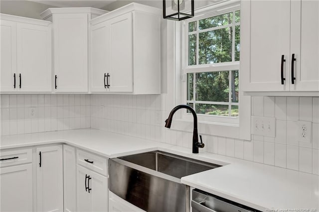 4037 Fulford Mcmillan Rd, Raeford, NC 28376 - kitchen with a sink, dishwasher, white cabinetry, tasteful backsplash, and light countertops