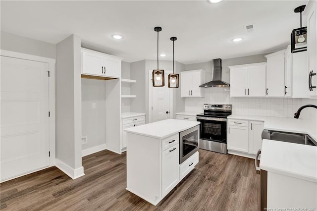 4037 Fulford Mcmillan Rd, Raeford, NC 28376 - kitchen with wall chimney range hood, appliances with stainless steel finishes, a sink, a center island, and dark wood-style floors