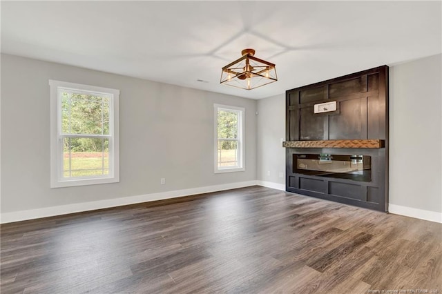 4037 Fulford Mcmillan Rd, Raeford, NC 28376 - unfurnished living room with a chandelier, dark wood-style flooring, and baseboards