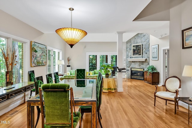 81106 Alexander, Chapel Hill, NC 27517 - dining space featuring light wood-style flooring, a stone fireplace, and vaulted ceiling