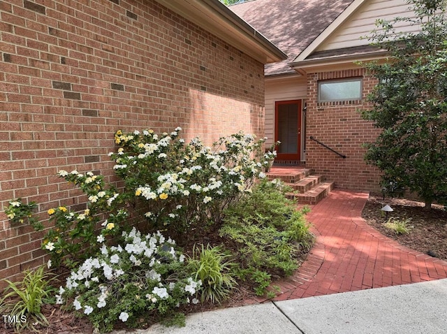 81106 Alexander, Chapel Hill, NC 27517 - doorway to property featuring a shingled roof and brick siding