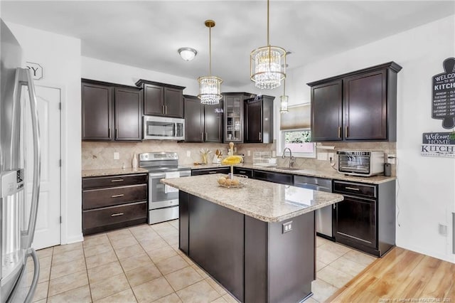 374 Boswell St, Raeford, NC 28376 - kitchen featuring appliances with stainless steel finishes, a chandelier, and dark brown cabinetry