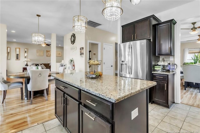374 Boswell St, Raeford, NC 28376 - kitchen featuring a chandelier, stainless steel fridge with ice dispenser, light tile patterned floors, dark brown cabinets, and decorative light fixtures