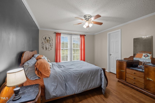 1993 Lucy Garrett Rd, Roxboro, NC 27574 - bedroom with wood finished floors, crown molding, a textured ceiling, and ceiling fan