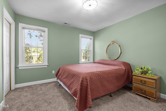 1 Gatesway Ct, Durham, NC 27707 - carpeted bedroom featuring a textured ceiling and baseboards