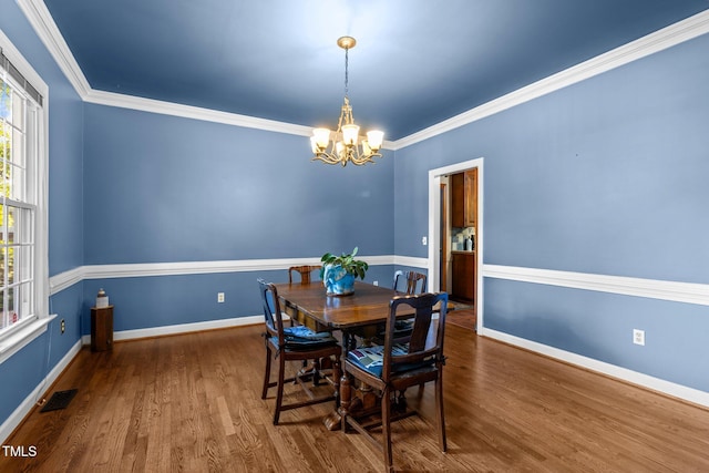 1 Gatesway Ct, Durham, NC 27707 - dining area with a chandelier, wood finished floors, and crown molding