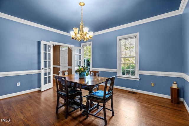 1 Gatesway Ct, Durham, NC 27707 - dining area with a chandelier, french doors, plenty of natural light, wood finished floors, and ornamental molding