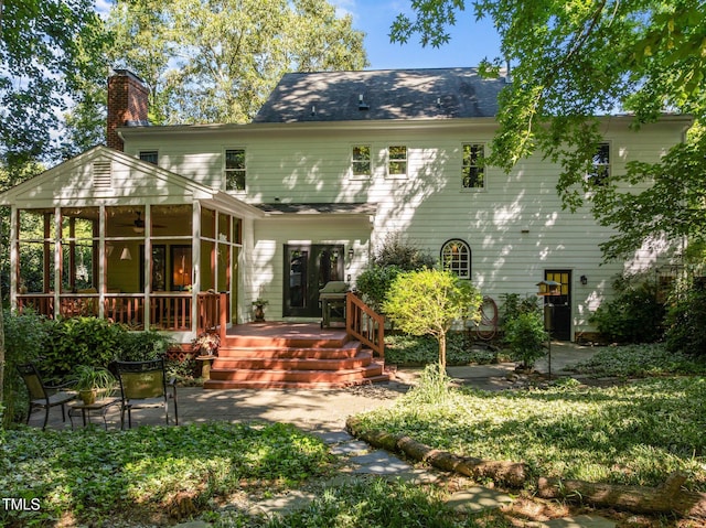 1 Gatesway Ct, Durham, NC 27707 - back of property featuring a sunroom, a chimney, a wooden deck, ceiling fan, and a patio