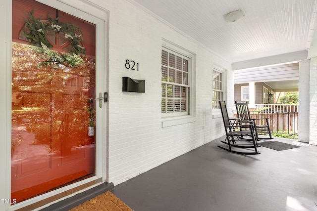 821 Onslow St, Durham, NC 27705 - view of exterior entry featuring covered porch and brick siding
