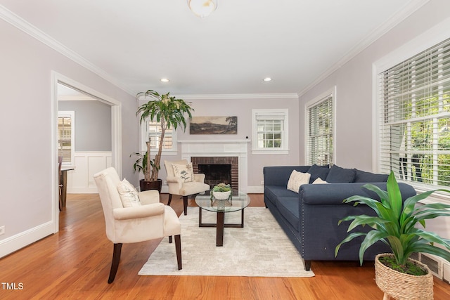 821 Onslow St, Durham, NC 27705 - living room featuring light wood-type flooring, healthy amount of natural light, ornamental molding, a brick fireplace, and recessed lighting