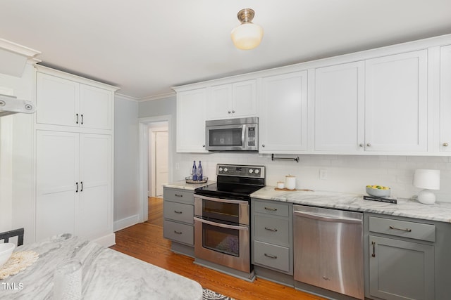 821 Onslow St, Durham, NC 27705 - kitchen with stainless steel appliances, gray cabinetry, tasteful backsplash, and crown molding