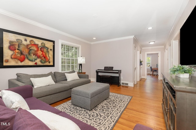 821 Onslow St, Durham, NC 27705 - living area featuring light wood-style floors, healthy amount of natural light, ornamental molding, and recessed lighting