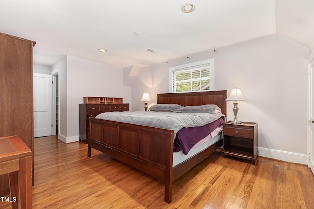 821 Onslow St, Durham, NC 27705 - bedroom featuring light wood-type flooring, recessed lighting, and vaulted ceiling