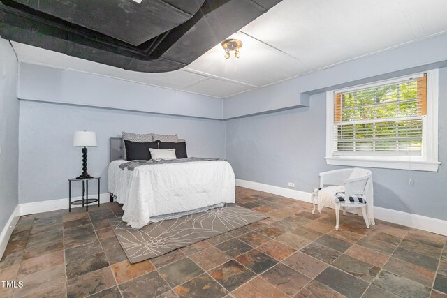 821 Onslow St, Durham, NC 27705 - bedroom featuring stone tile flooring and baseboards