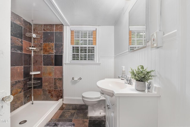 821 Onslow St, Durham, NC 27705 - bathroom with tiled shower, vanity, and stone finish floors