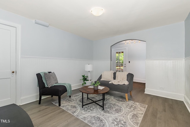 821 Onslow St, Durham, NC 27705 - sitting room featuring a wainscoted wall, arched walkways, and wood finished floors
