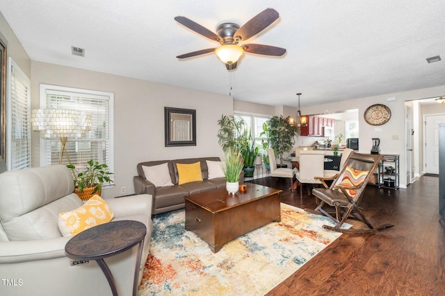 4361 Bona Ct, Raleigh, NC 27604 - living area with dark wood-type flooring, a ceiling fan, and a textured ceiling