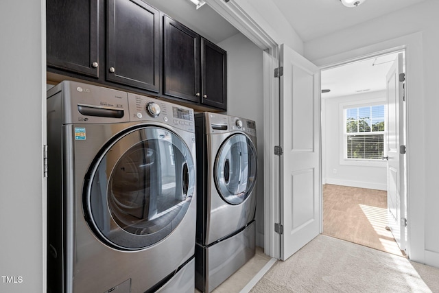 531 N Person St Unit 205, Raleigh, NC 27604 - laundry room with washer and dryer, cabinet space, and light colored carpet