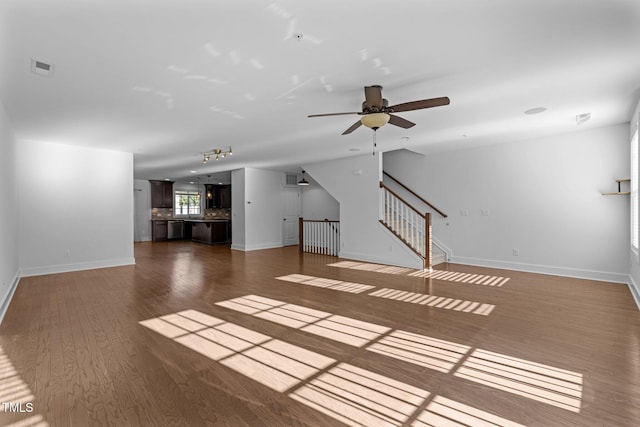 531 N Person St Unit 205, Raleigh, NC 27604 - unfurnished living room with wood finished floors, a ceiling fan, baseboards, and stairs