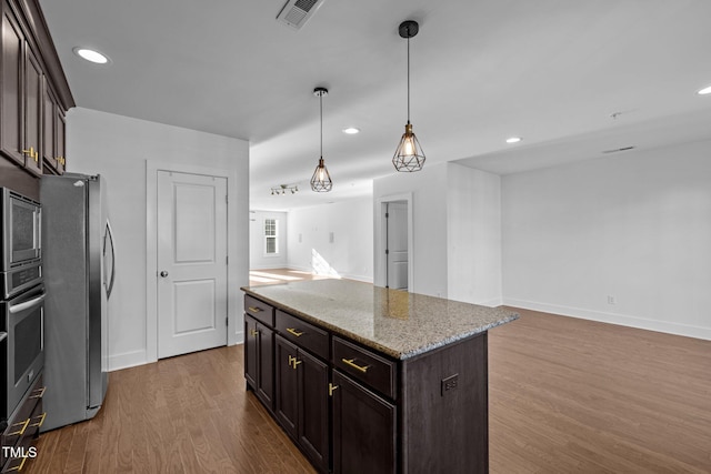 531 N Person St Unit 205, Raleigh, NC 27604 - kitchen featuring stainless steel appliances, open floor plan, dark wood-style floors, dark brown cabinetry, and hanging light fixtures