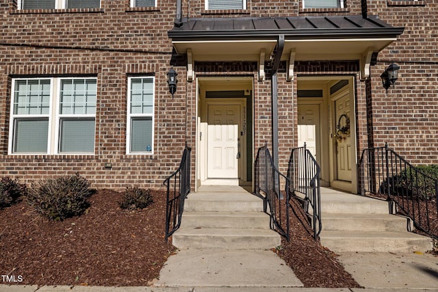 531 N Person St Unit 205, Raleigh, NC 27604 - doorway to property featuring brick siding, a standing seam roof, and metal roof