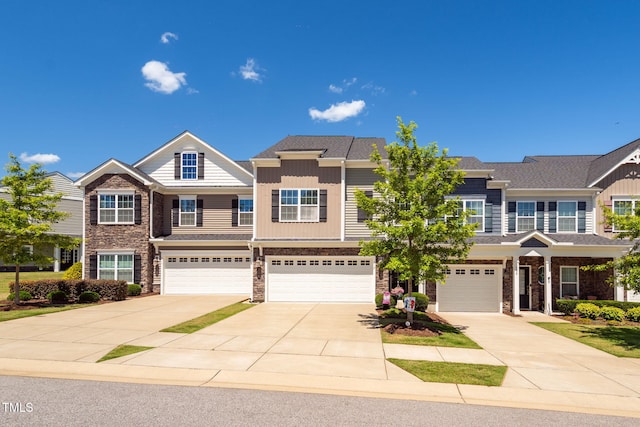 512 Barneswyck Dr, Fuquay Varina, NC 27526 - view of front facade with driveway, a garage, and stone siding