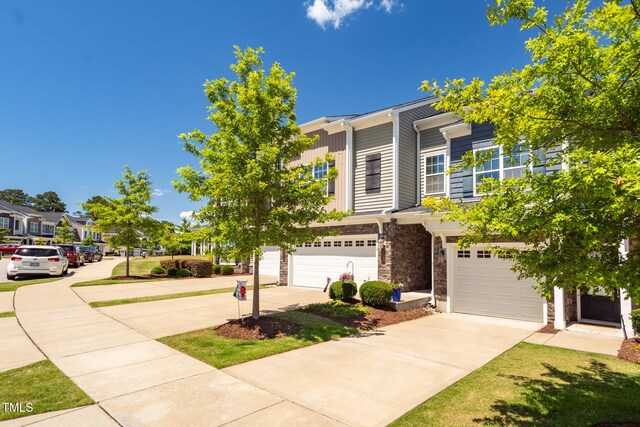 512 Barneswyck Dr, Fuquay Varina, NC 27526 - view of front of home featuring driveway, stone siding, an attached garage, and a residential view