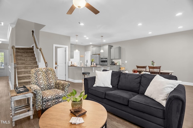512 Barneswyck Dr, Fuquay Varina, NC 27526 - living area featuring wood finished floors, a ceiling fan, recessed lighting, baseboards, and stairway