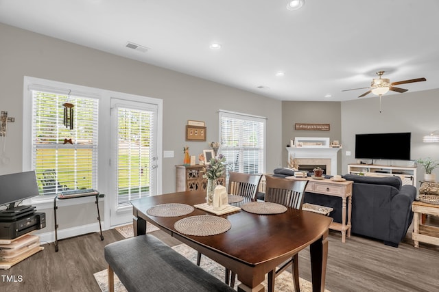 512 Barneswyck Dr, Fuquay Varina, NC 27526 - dining space featuring wood finished floors, ceiling fan, a fireplace, recessed lighting, and baseboards