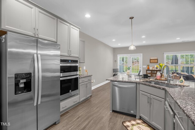 512 Barneswyck Dr, Fuquay Varina, NC 27526 - kitchen with appliances with stainless steel finishes, a sink, gray cabinets, light wood-style floors, and recessed lighting