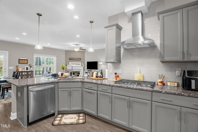 512 Barneswyck Dr, Fuquay Varina, NC 27526 - kitchen featuring gray cabinets, stainless steel appliances, wall chimney range hood, a sink, and healthy amount of natural light