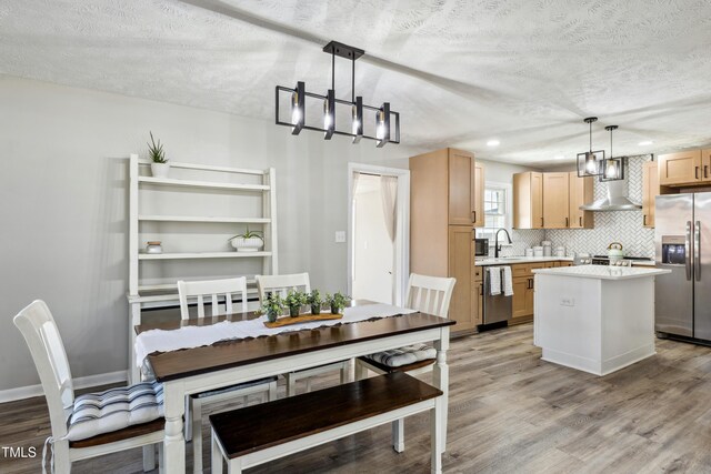 1841 Conover Dr, Fayetteville, NC 28304 - dining space with light wood-style flooring, a chandelier, and a textured ceiling