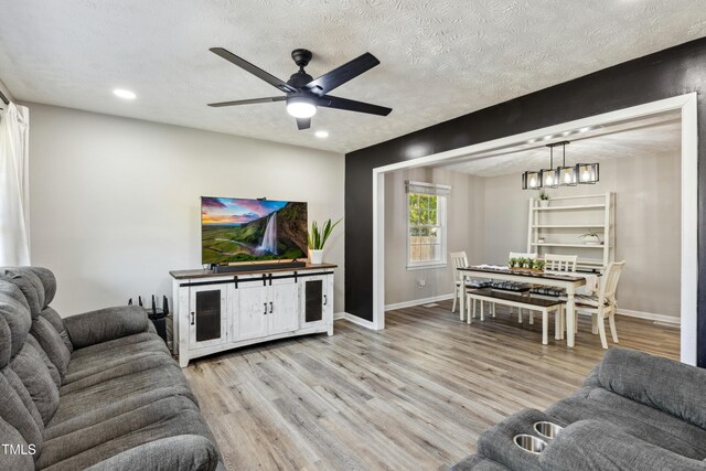 1841 Conover Dr, Fayetteville, NC 28304 - living room featuring recessed lighting, light wood-style floors, baseboards, ceiling fan, and a textured ceiling