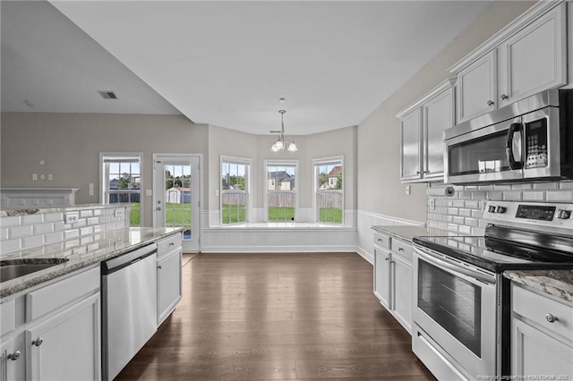254 Blackhawk Ln, Raeford, NC 28376 - kitchen with appliances with stainless steel finishes, dark wood-type flooring, decorative backsplash, light stone countertops, and baseboards