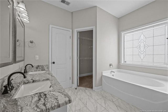 254 Blackhawk Ln, Raeford, NC 28376 - full bath with a garden tub, double vanity, baseboards, marble finish floors, and a walk in closet