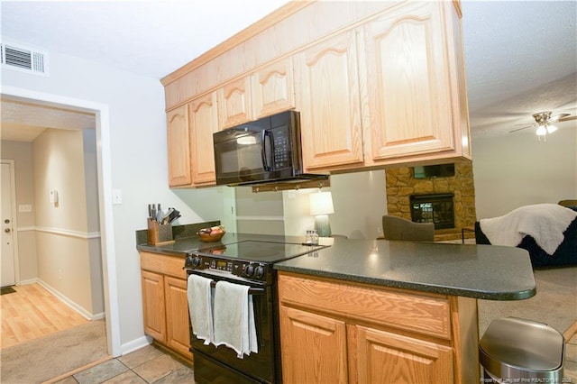 6874 Fern Creek Pl, Fayetteville, NC 28314 - kitchen featuring black appliances, dark countertops, a stone fireplace, and light brown cabinets