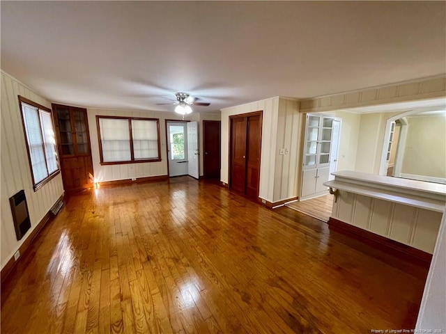1007 Jenkins St, Lumberton, NC 28358 - empty room featuring a decorative wall, hardwood / wood-style floors, ceiling fan, and baseboards
