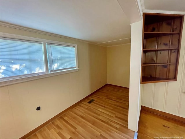 1007 Jenkins St, Lumberton, NC 28358 - empty room with light wood-type flooring, ornamental molding, and baseboards