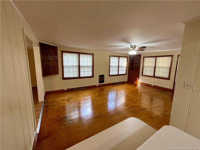 1007 Jenkins St, Lumberton, NC 28358 - unfurnished living room with wood-type flooring, a ceiling fan, and baseboards