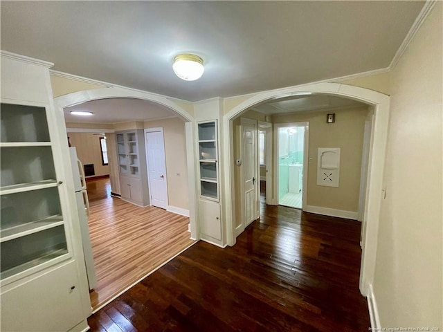 1007 Jenkins St, Lumberton, NC 28358 - spare room with arched walkways, wood-type flooring, crown molding, built in features, and baseboards