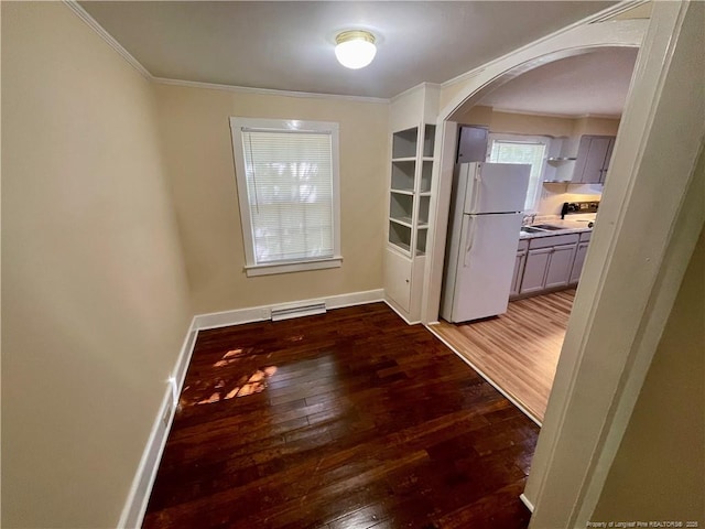 1007 Jenkins St, Lumberton, NC 28358 - empty room featuring arched walkways, hardwood / wood-style floors, healthy amount of natural light, crown molding, and baseboards