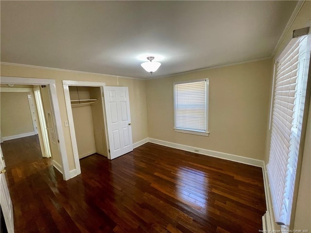 1007 Jenkins St, Lumberton, NC 28358 - unfurnished bedroom featuring crown molding, dark wood finished floors, baseboards, and a closet