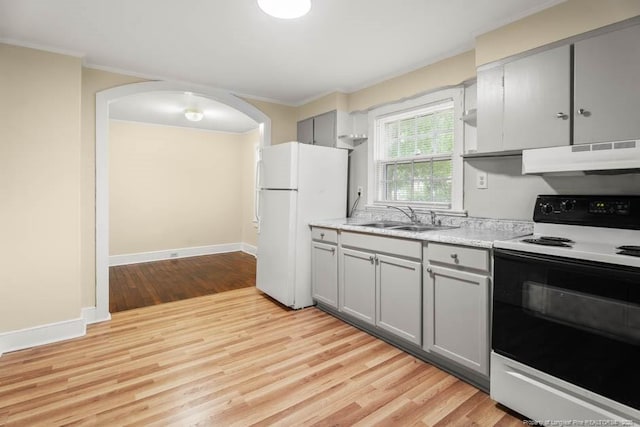 1007 Jenkins St, Lumberton, NC 28358 - kitchen with electric range oven, under cabinet range hood, freestanding refrigerator, gray cabinetry, and crown molding